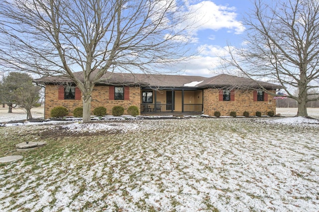 single story home with covered porch and brick siding