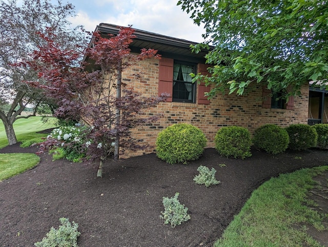 view of property exterior featuring brick siding