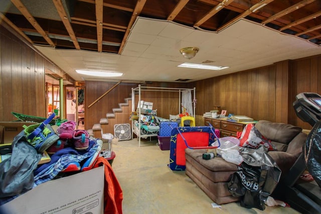 basement featuring wood walls