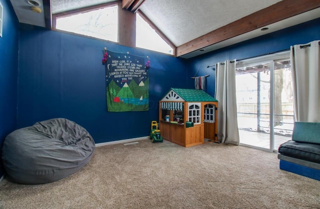 rec room featuring carpet, lofted ceiling with beams, and a textured ceiling