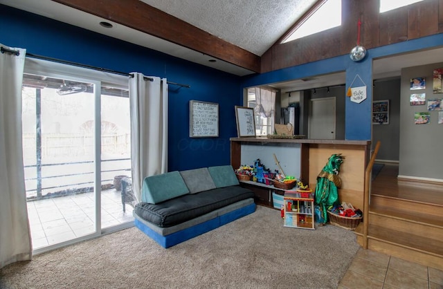 interior space featuring vaulted ceiling, tile patterned flooring, and a textured ceiling