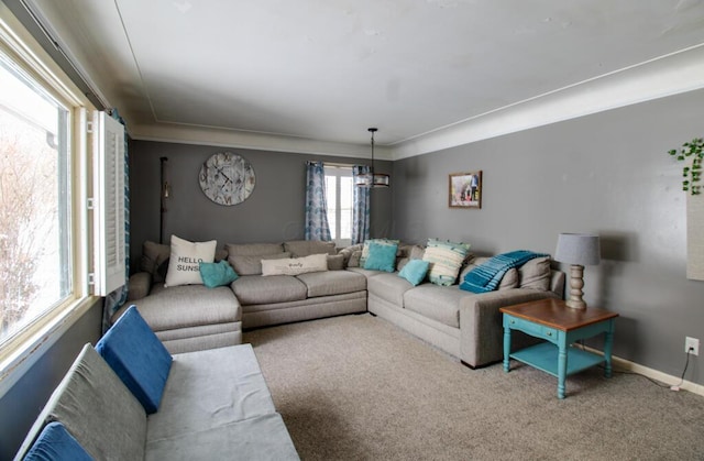 carpeted living room with crown molding