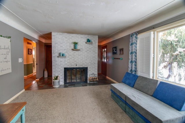 living room featuring dark carpet and a fireplace