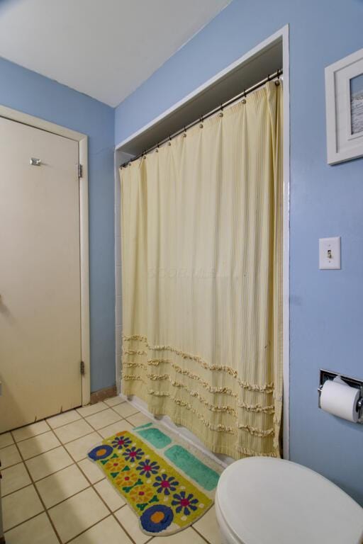 bathroom with tile patterned floors and toilet