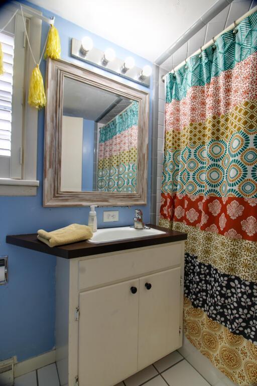 bathroom with tile patterned floors and vanity