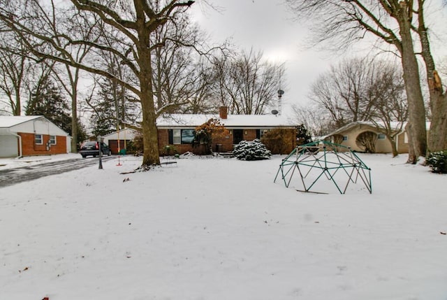 yard layered in snow featuring a garage