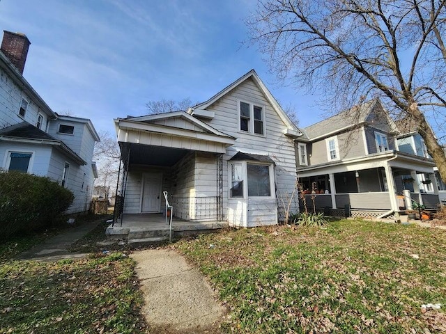 view of front of property with covered porch and a front yard