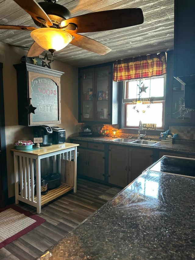 bar featuring a sink and dark wood-style flooring