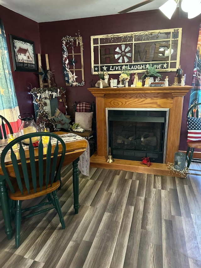 sitting room with a fireplace and wood finished floors