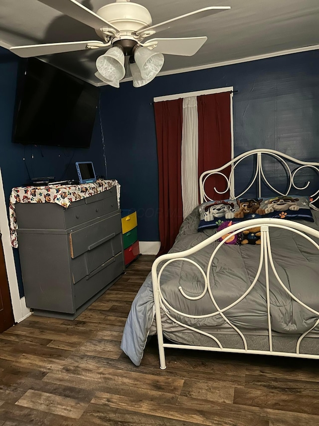 bedroom with a ceiling fan and wood finished floors