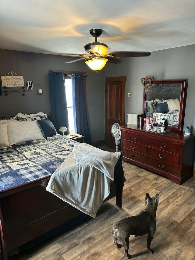 bedroom with ceiling fan and wood finished floors