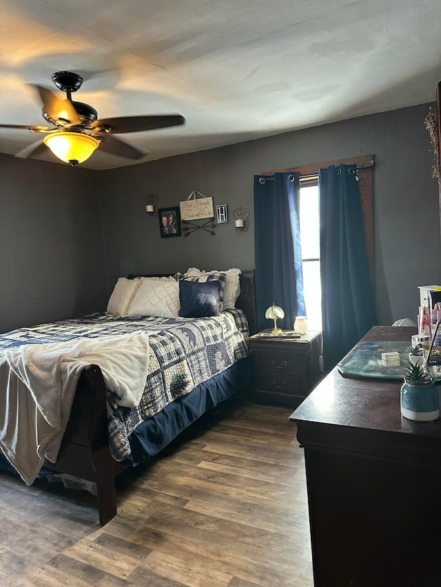 bedroom with ceiling fan and wood finished floors