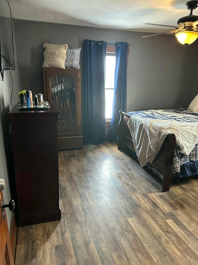 bedroom with a ceiling fan and wood finished floors