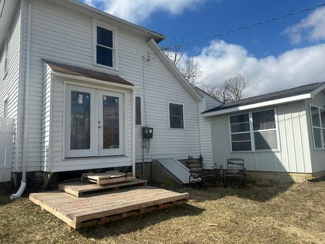 rear view of property featuring entry steps and french doors