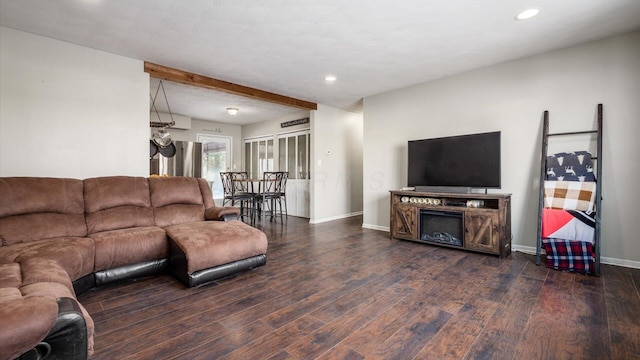 living room featuring beamed ceiling and dark hardwood / wood-style flooring