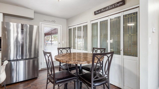 dining space with dark wood-type flooring