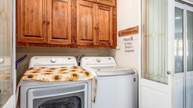 washroom featuring cabinets and independent washer and dryer