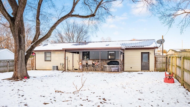 view of snow covered rear of property