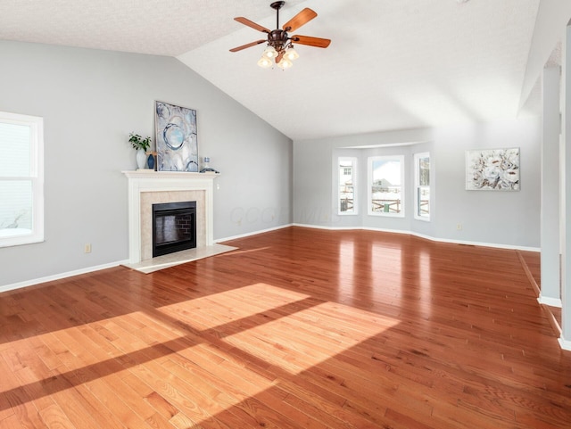 unfurnished living room featuring ceiling fan, wood-type flooring, and vaulted ceiling