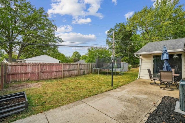 view of yard featuring a patio and a trampoline