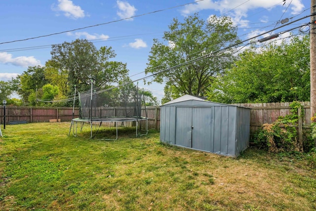 view of yard with a storage shed and a trampoline