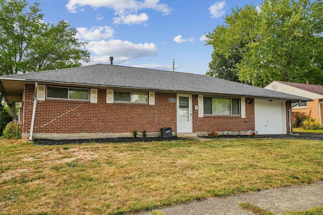 ranch-style home with a garage and a front lawn