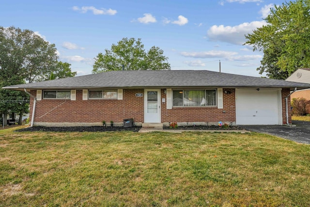 single story home featuring a garage and a front lawn