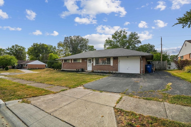 ranch-style home featuring a garage and a front lawn