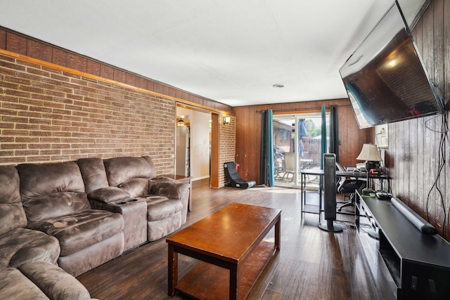 living room with wood-type flooring and brick wall