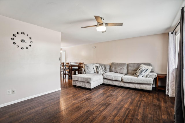 living room with ceiling fan and dark hardwood / wood-style floors