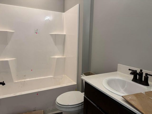 bathroom with vanity, shower / tub combination, and toilet