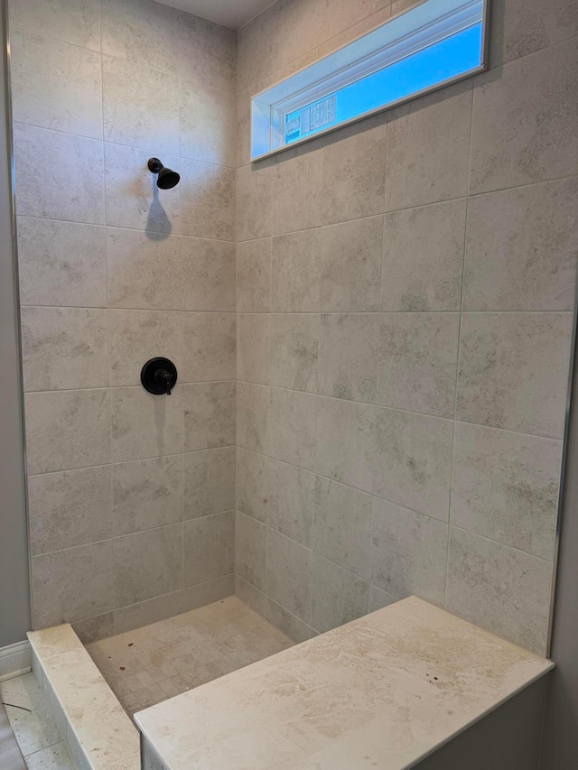 full bathroom featuring a tile shower