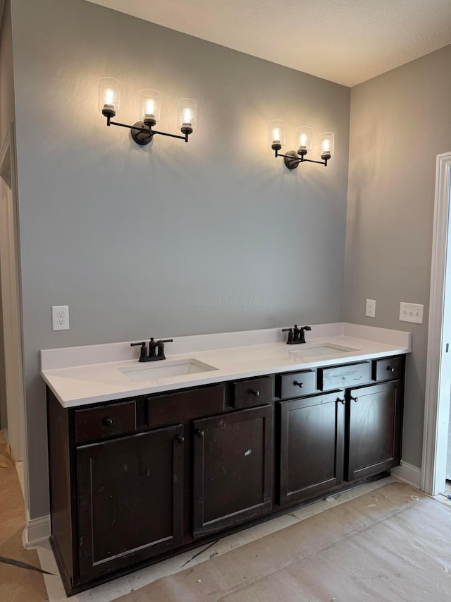 bathroom with baseboards and a sink