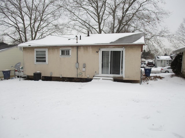 view of snow covered back of property