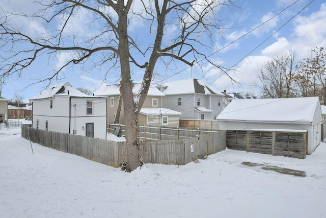 view of snow covered back of property