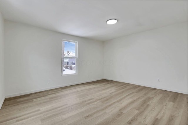 spare room featuring light wood-type flooring