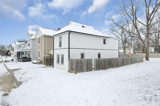 view of snow covered rear of property