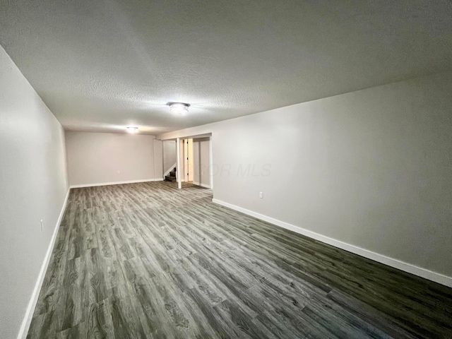 basement with a textured ceiling and hardwood / wood-style flooring