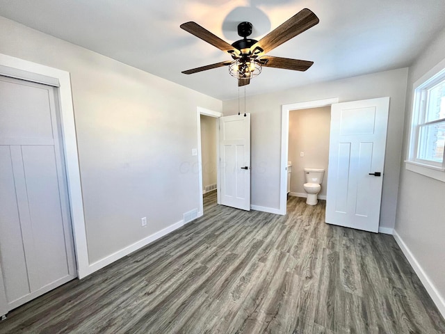 unfurnished bedroom featuring hardwood / wood-style floors, connected bathroom, and ceiling fan