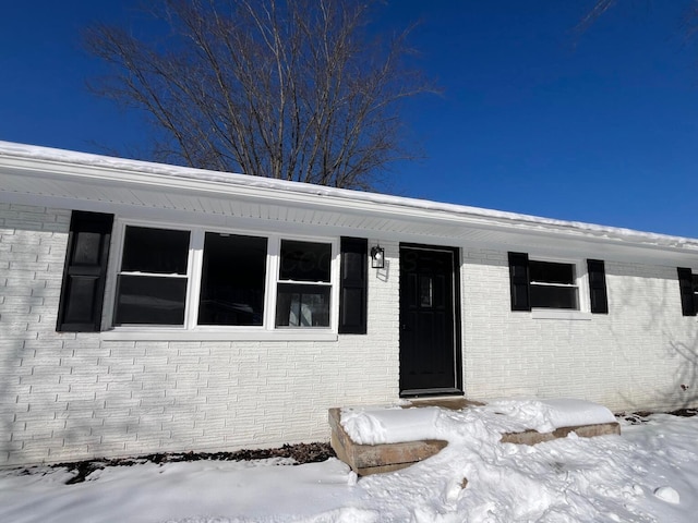 view of snow covered property entrance