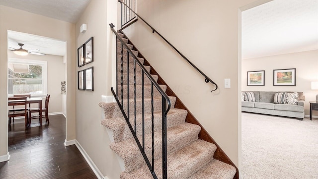 staircase with hardwood / wood-style flooring, ceiling fan, and a textured ceiling