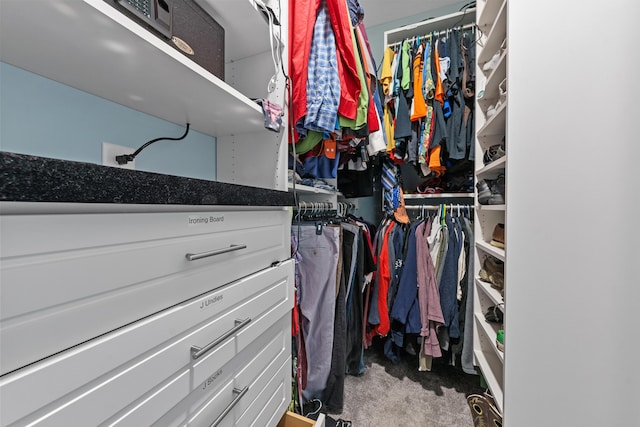 walk in closet featuring carpet floors