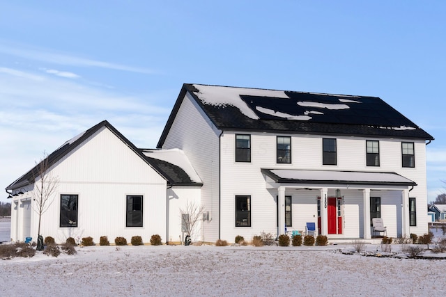 modern farmhouse with covered porch and a garage