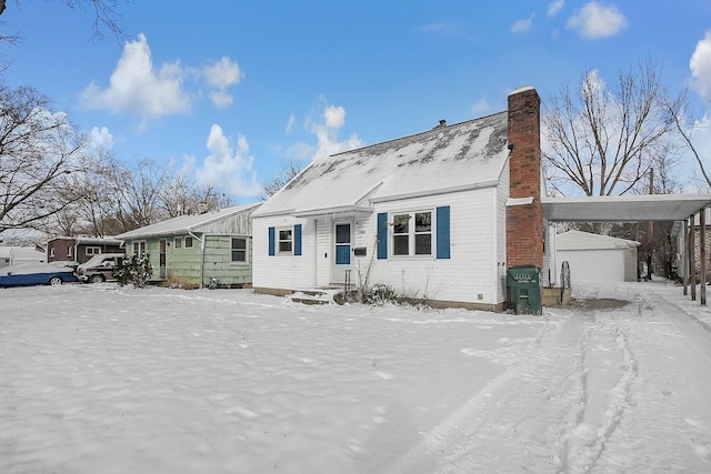 view of front facade with a garage and an outbuilding