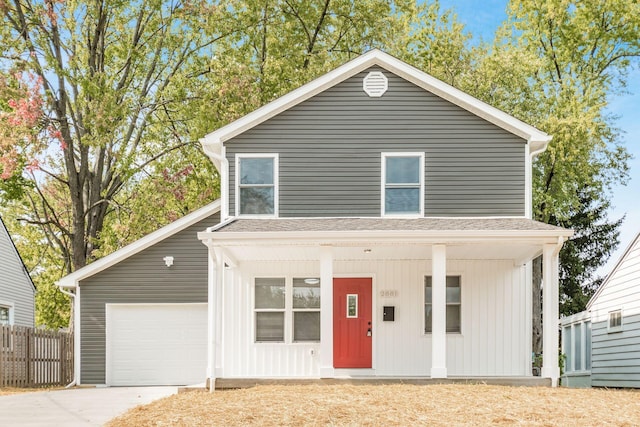 view of property featuring a garage and covered porch