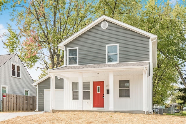 view of property featuring a porch and a garage