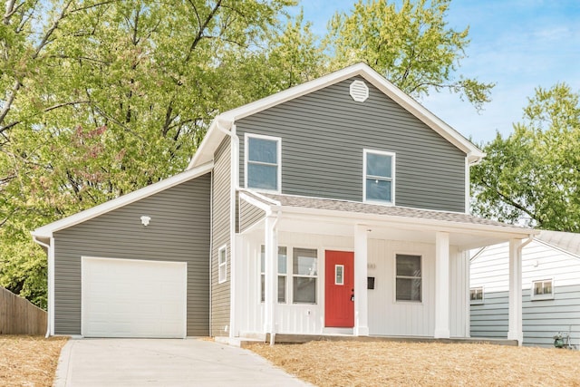 view of front property featuring covered porch and a garage