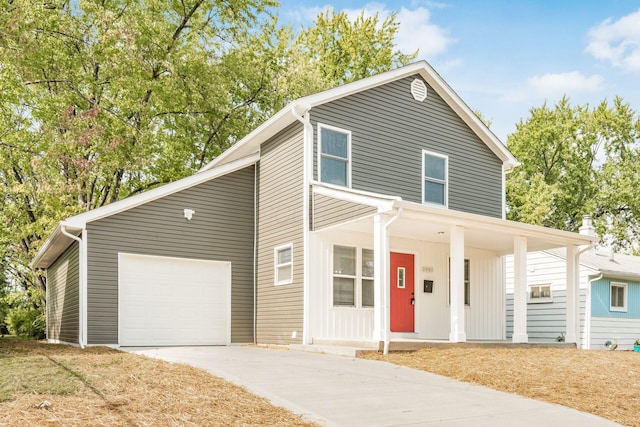 view of front property with a porch and a garage