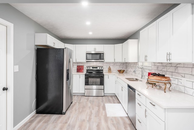 kitchen featuring white cabinets, sink, and stainless steel appliances