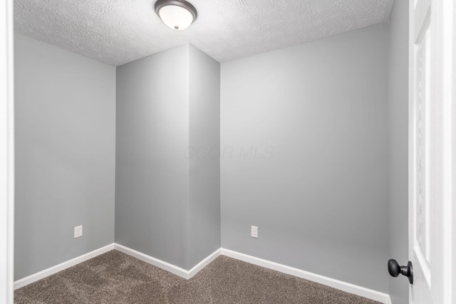 unfurnished room with carpet floors and a textured ceiling